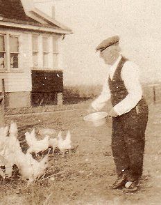 C. W. Netherwood feeding the chickens